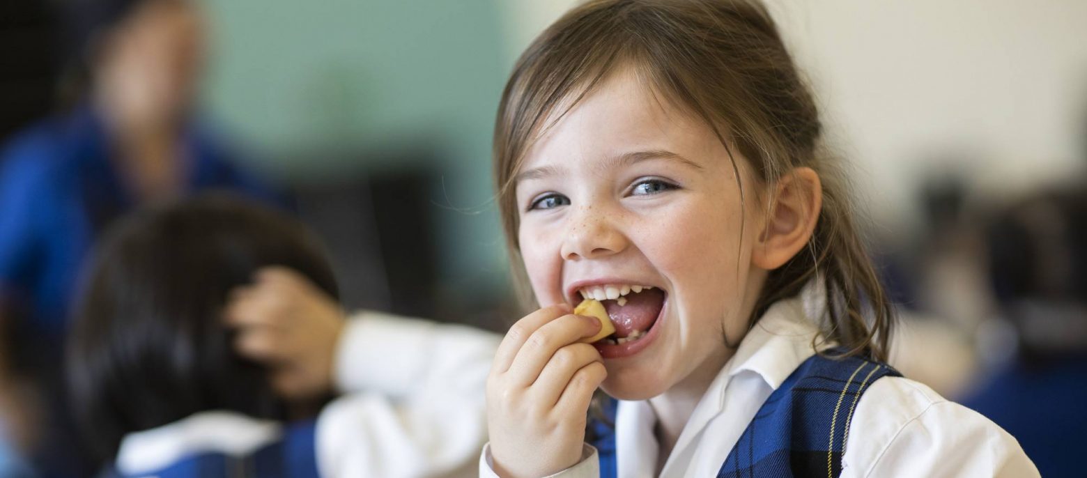 little girl eating a snack