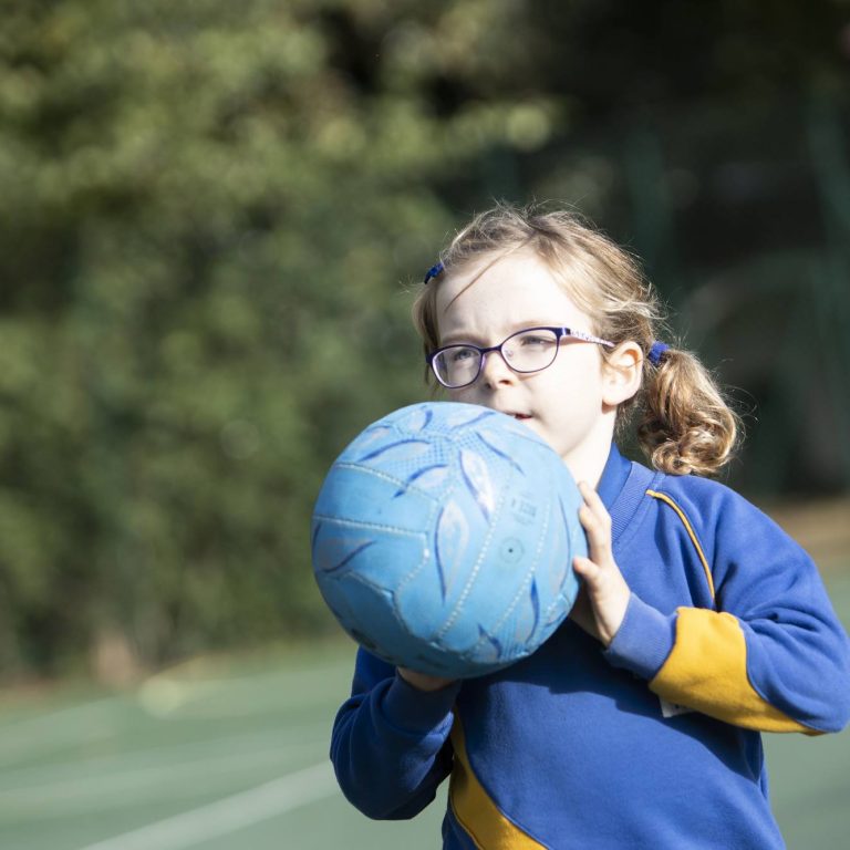 girl holding a ball