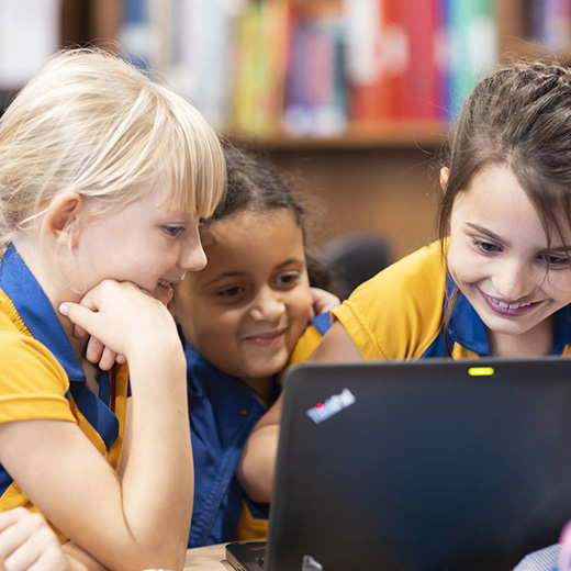 3 girls using a laptop