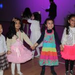 four young girls wearing disco outfits