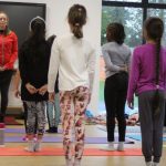 group of school girls having a yoga lesson