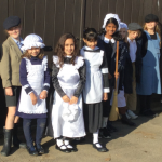 group of school girls dressed as victorians