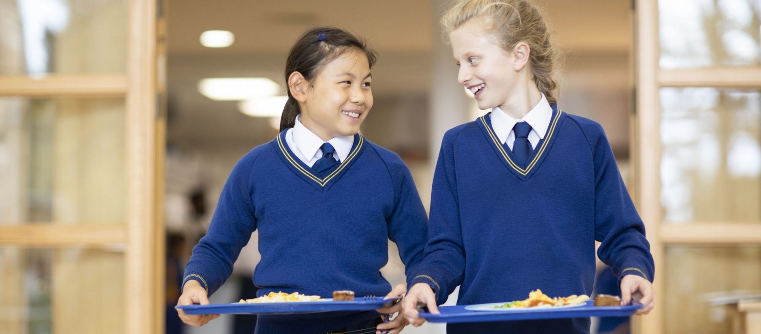 students walking with their dinner tray