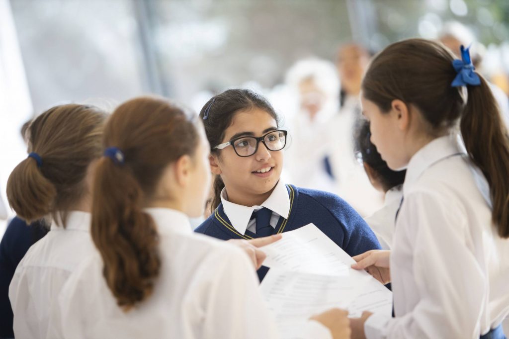 students reading sheets of information