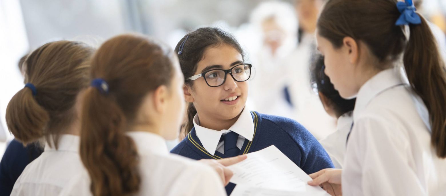 students reading sheets of information