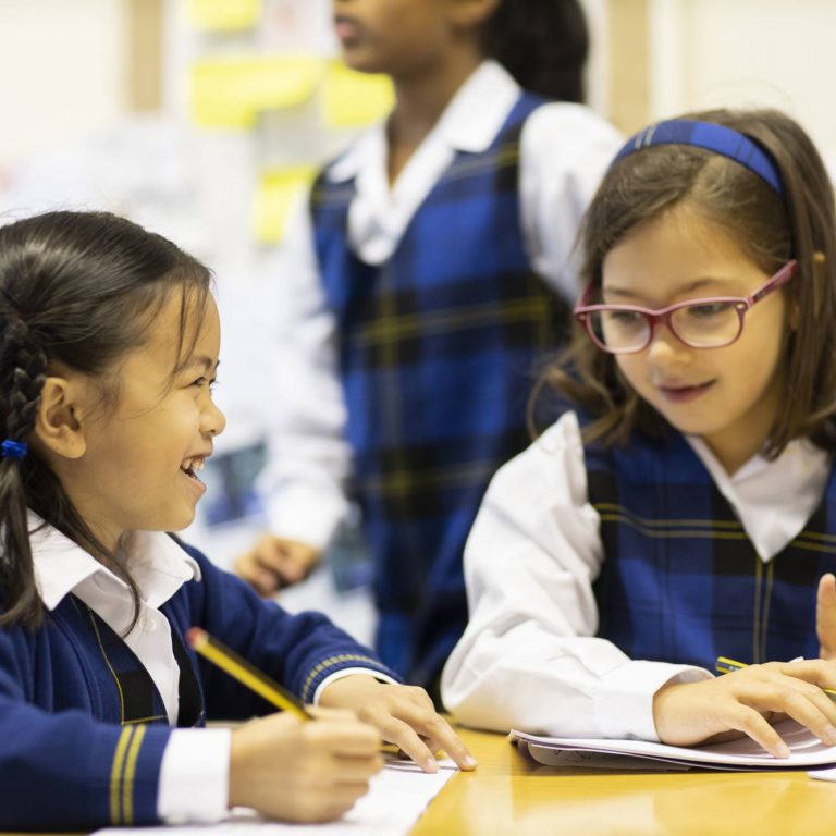 students writing with pencils