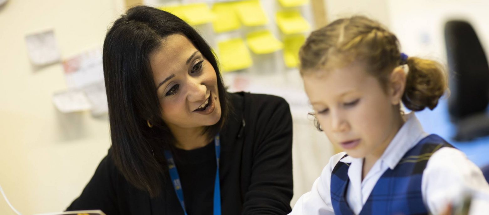 girl in class with a teacher