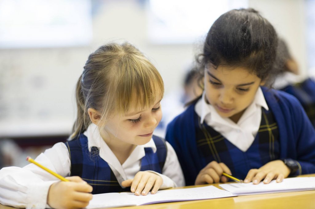 students helping each other in class