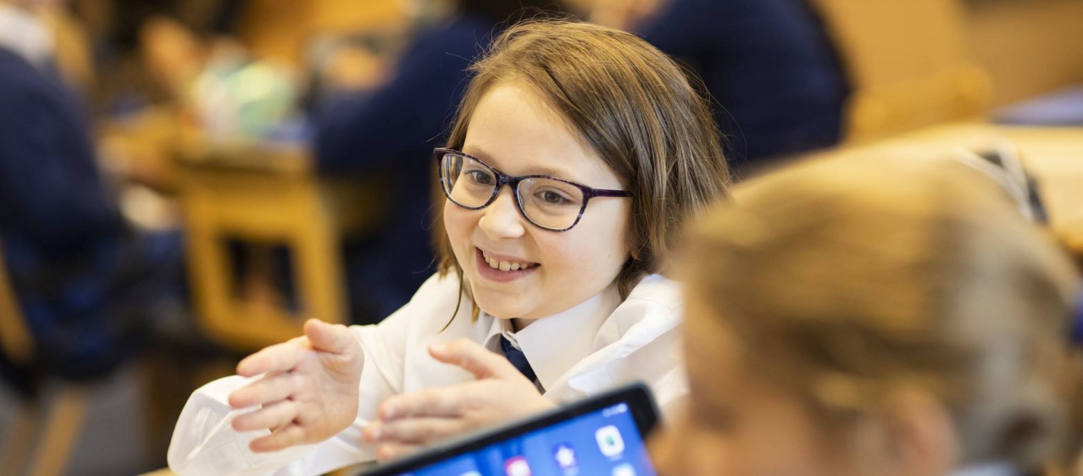 girl with their hands up wearing glasses