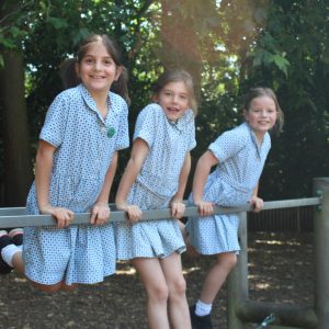 three school girls playing outdoors