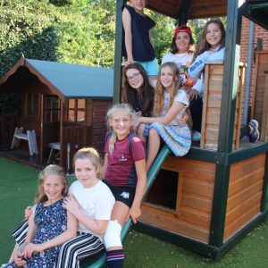 group of girls sitting on a slide