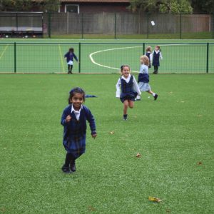 group of children playing on a school field