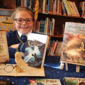 child surrounded by harry potter books