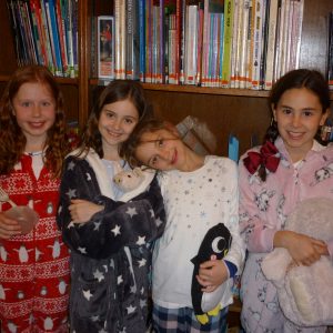 four young girls wearing pyjamas