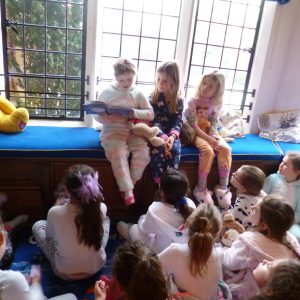 girls in pyjamas reading