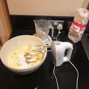 cake being made using a hand whisk