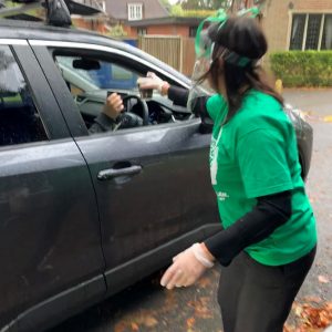 teacher giving a driver some coffee in a cup