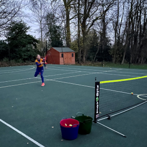 child playing tennis