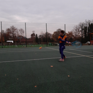 child hitting tennis balls