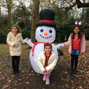 3 girls holding an inflatable snowman