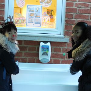 2 girls washing their hands