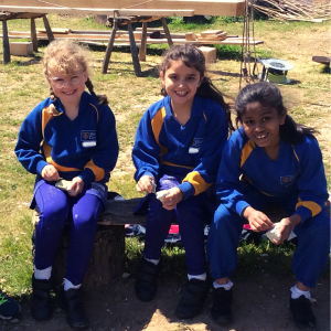 3 students holding rocks