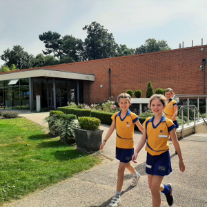 3 students walking across