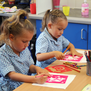 2 girls drawing with stencils