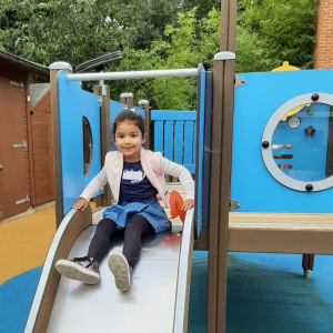 A child going down a park slide