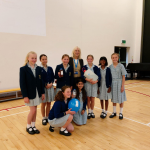 pupils smiling with their teacher