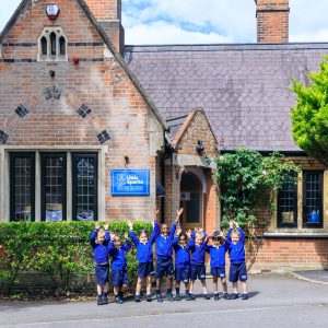 children standing infront of a school building
