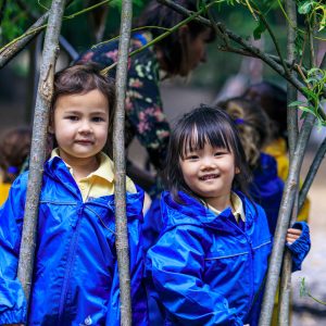 girls in blue raincoats outside