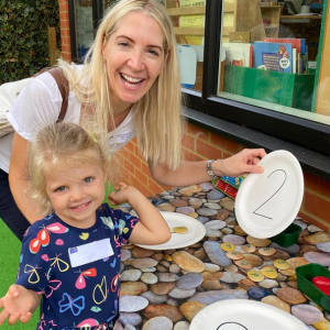 girl and her teacher with numbered paper plates