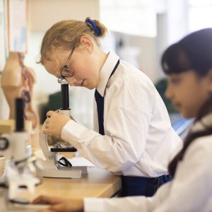 student using a microscope