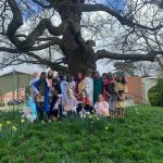 the group of students from the Holy Week performance stood next to a tree